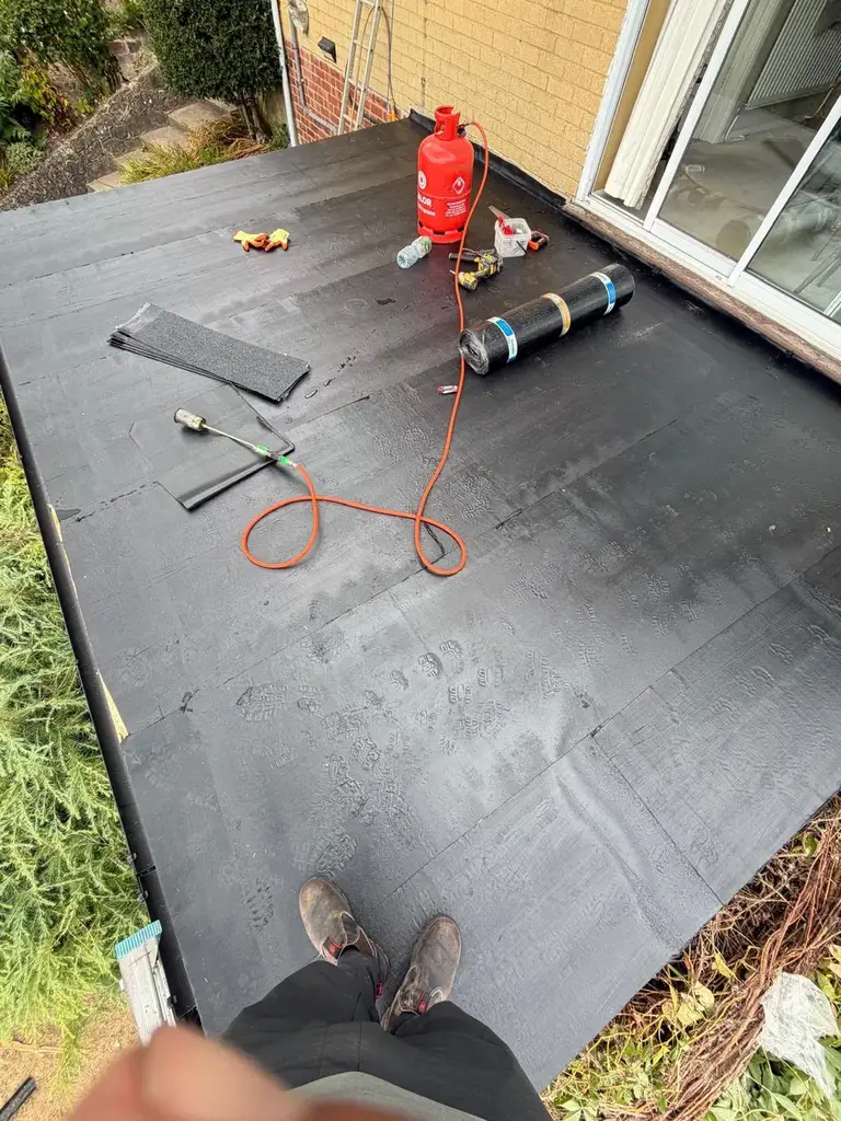 Torch-on felt being laid on the Chatham flat roof