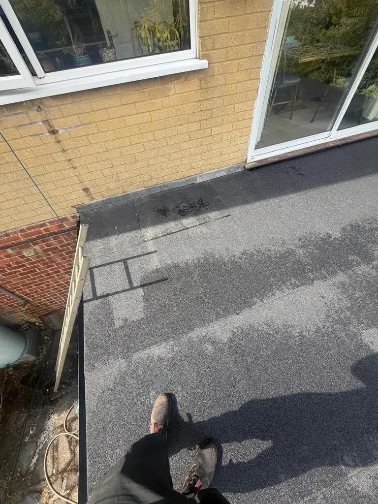 Roof detail at a wall abutment repaired and flashed