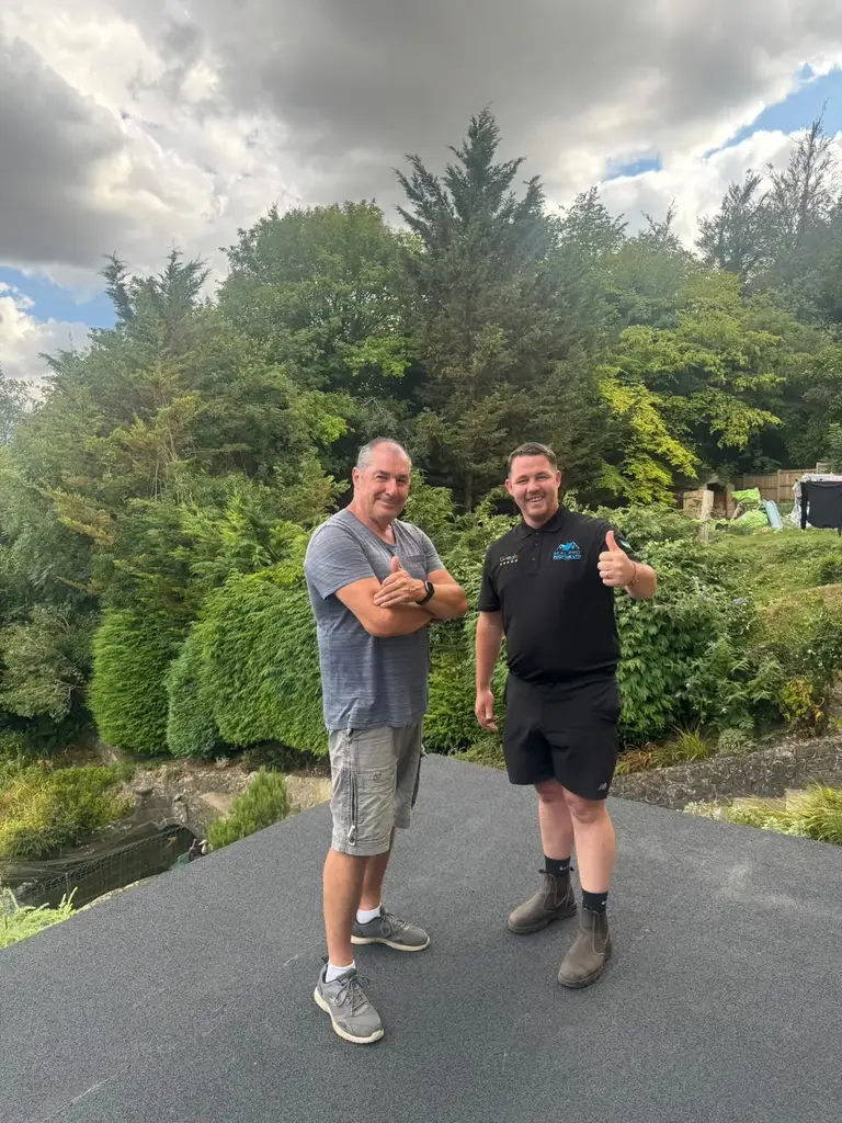 The customer with owner Cornelius on the finished flat roof in Chatham
