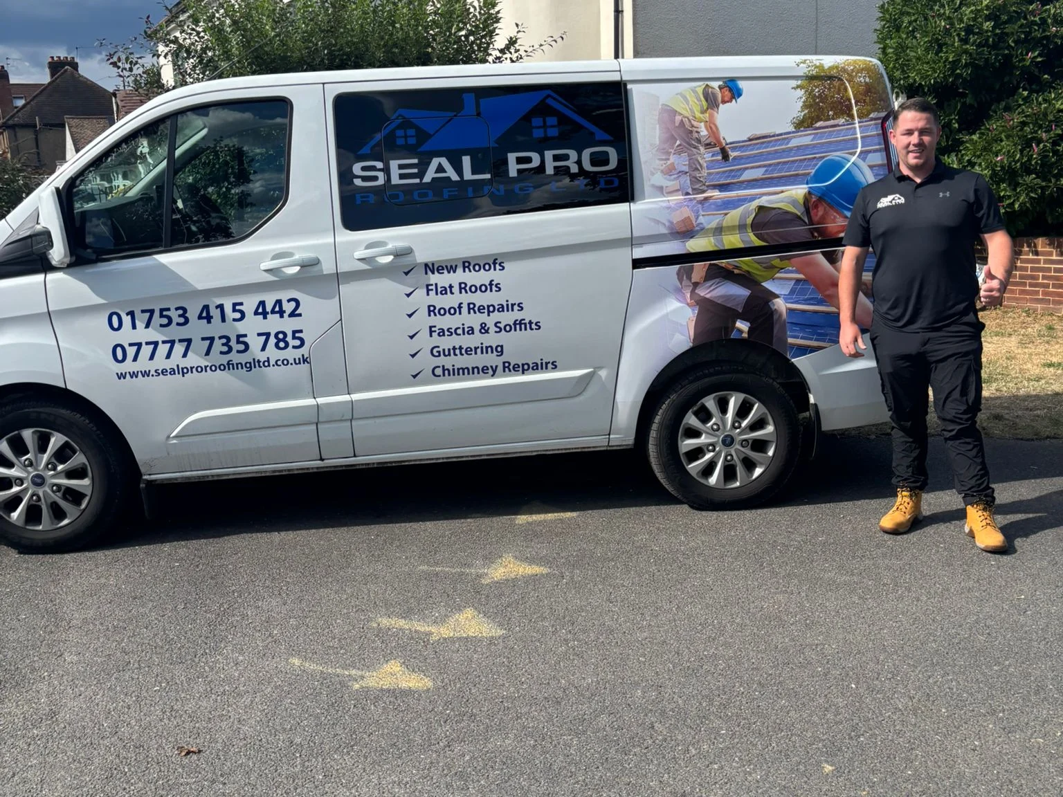 Cornelius, owner of Seal Pro Roofing Ltd, standing beside the Seal Pro Roofing van