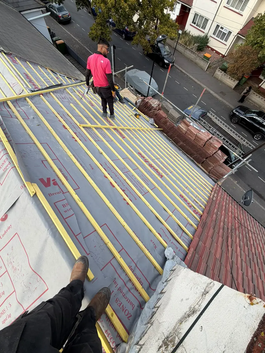 New treated battens running across the East Ham roof with the street below