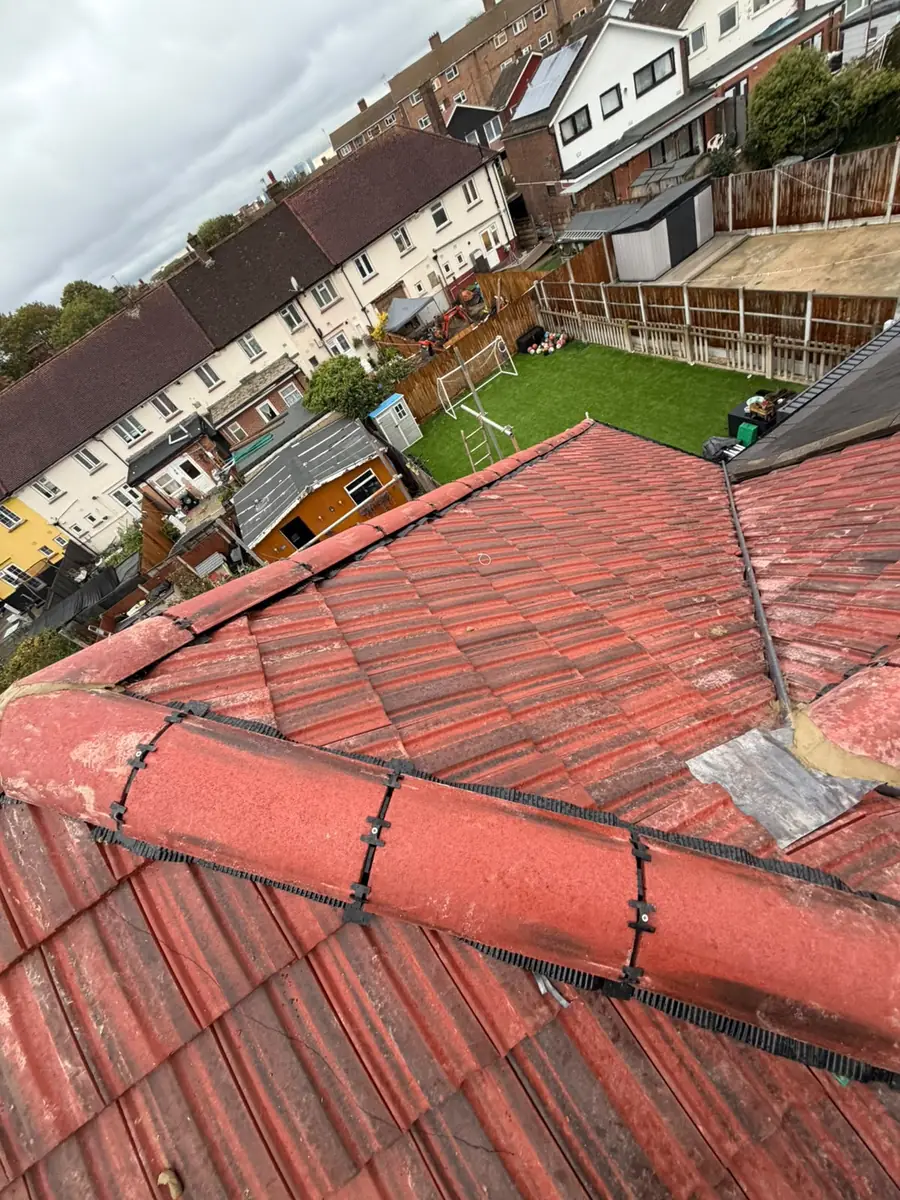 Finished full re-roof with red interlocking tiles and a dry ridge in East Ham
