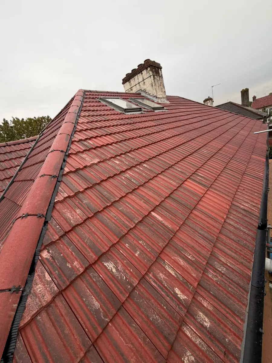 Finished hipped roof in East Ham with red tiles and a dry hip