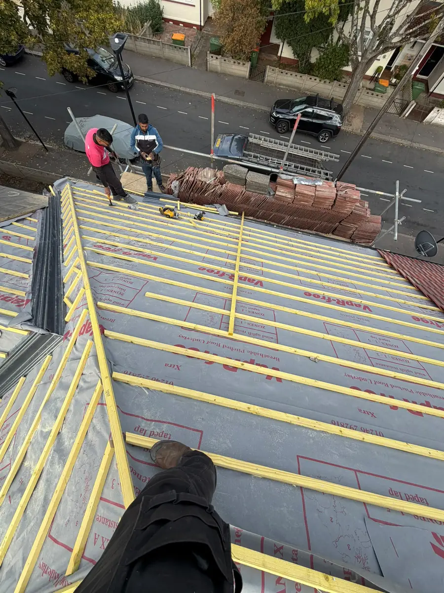 The Seal Pro team loading tiles on the scaffold over the street in East Ham