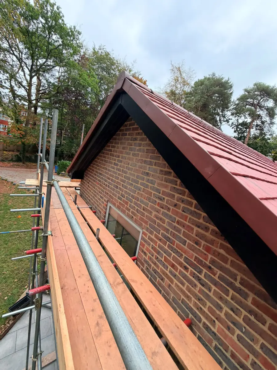 Gable end with new black fascias and bargeboards and a dry verge on the Fleet re-roof