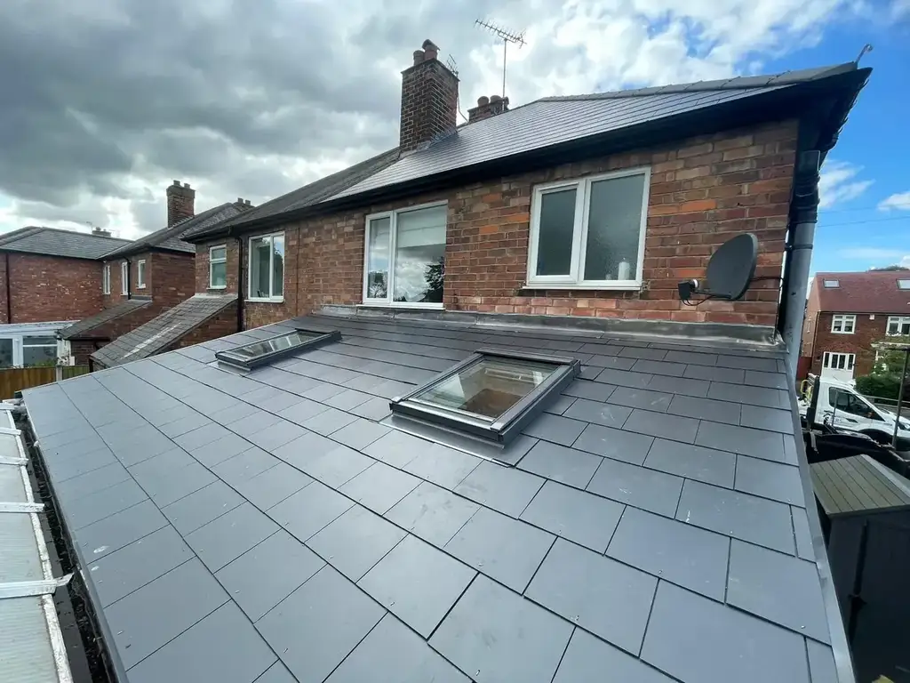 Two roof windows set into a slate-effect lean-to roof on a recent job