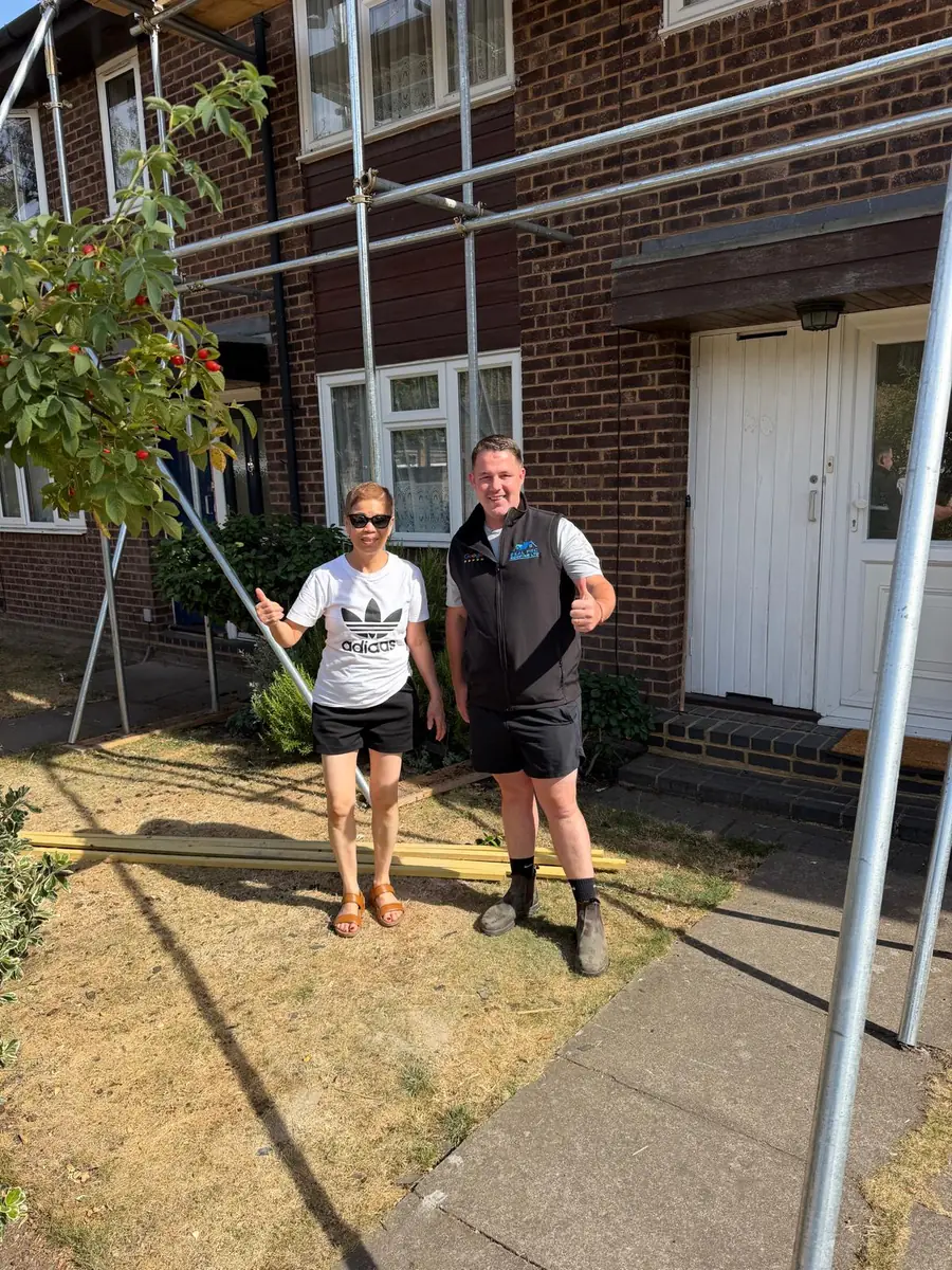 The customer with owner Cornelius outside the finished Hampton property