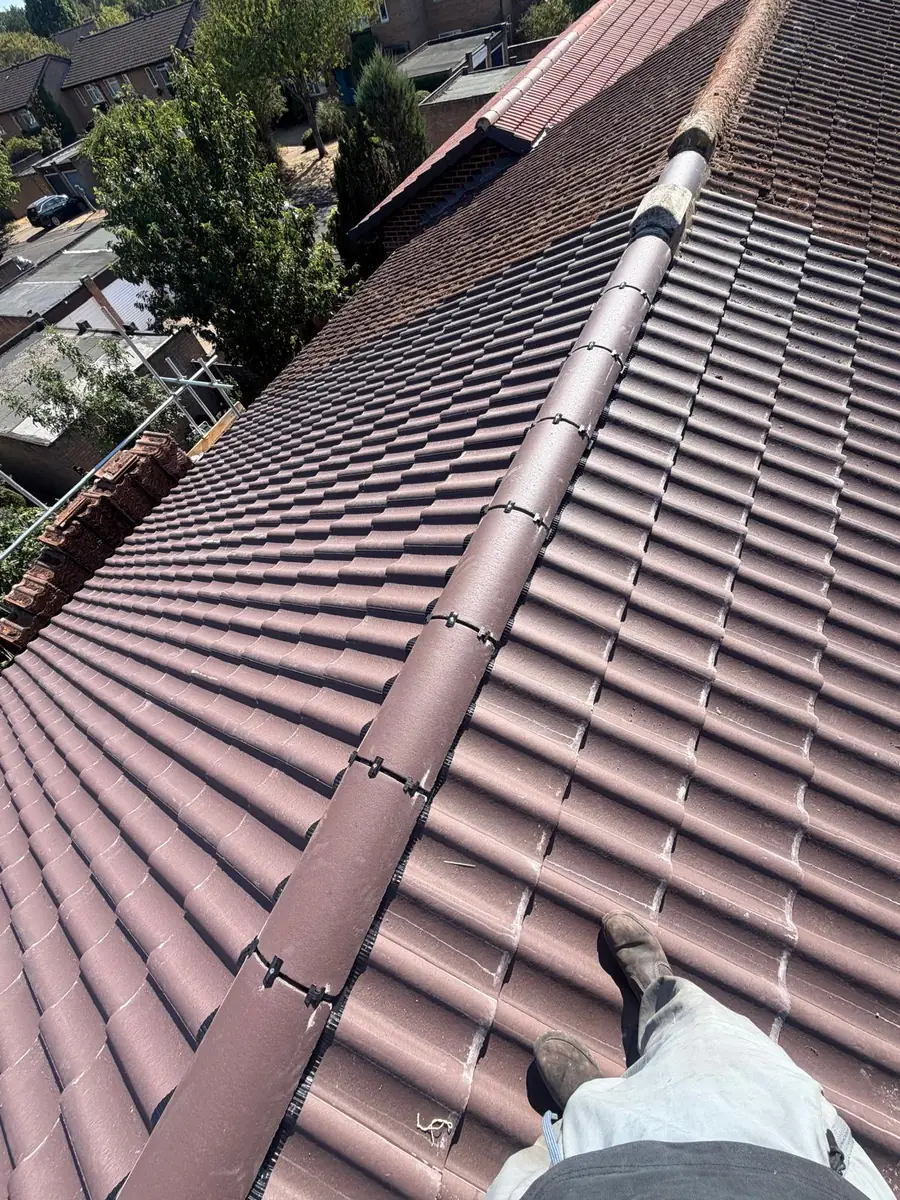 Finished tiled roof in Hampton with a mechanically fixed dry ridge running along the hip