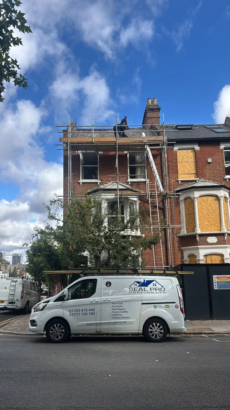 Seal Pro Roofing van outside a scaffolded Victorian house during roof works
